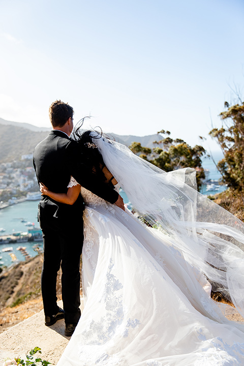  classic wedding on Catalina with the groom and groomsmen in black tuxedos and the bridesmaids in blush gowns 