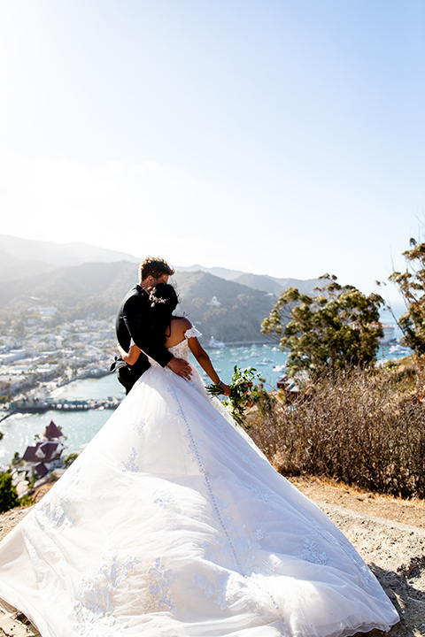  classic wedding on Catalina with the groom and groomsmen in black tuxedos and the bridesmaids in blush gowns 