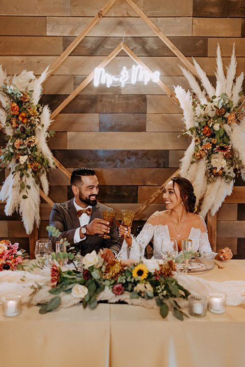  rustic bohemian wedding with brown and gold color scheme – couple at reception 