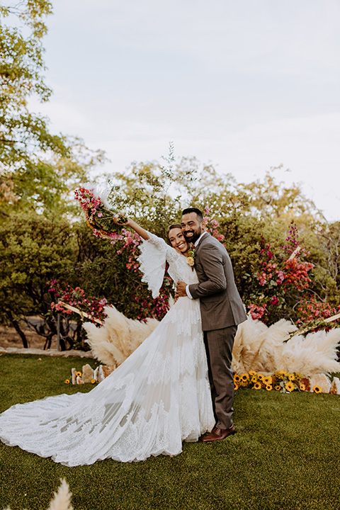  rustic bohemian wedding with brown and gold color scheme – couple first kiss 