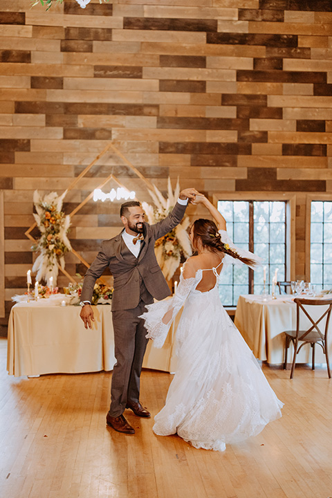  rustic bohemian wedding with brown and gold color scheme – couple at first dance