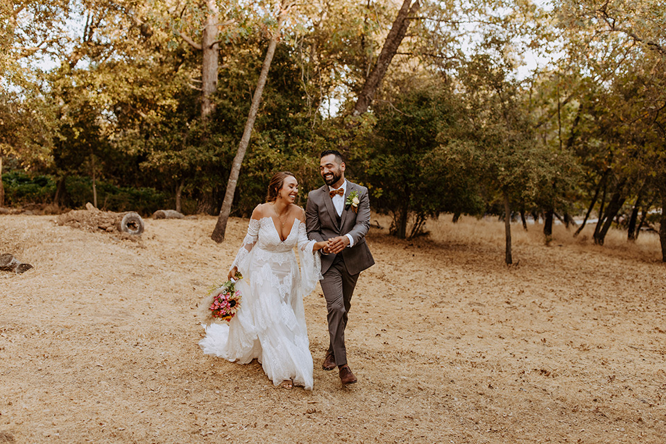  rustic bohemian wedding with brown and gold color scheme – couple walking 