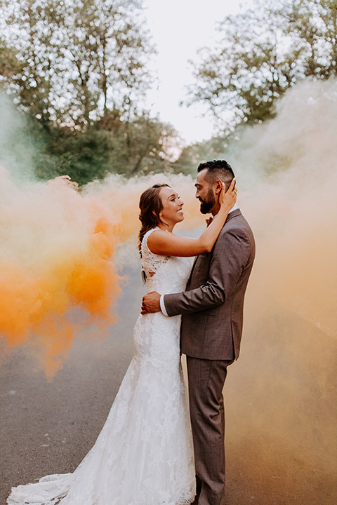  rustic bohemian wedding with brown and gold color scheme – couple in smoke bomb
