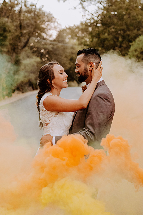  rustic bohemian wedding with brown and gold color scheme – couple in smoke bomb 