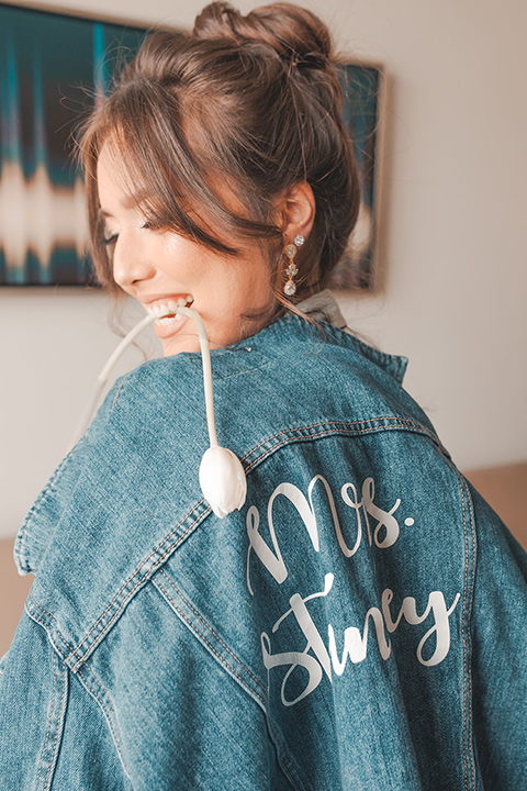  hangar 21 fullerton wedding with navy and bohemian style – bride in jean jacket 