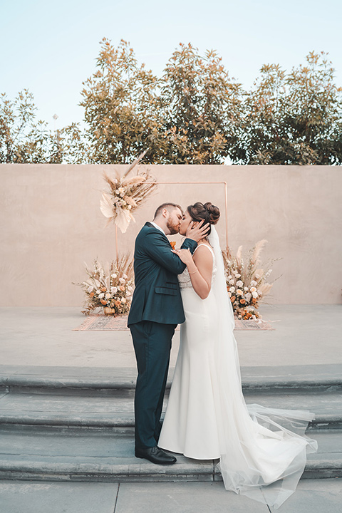  hangar 21 fullerton wedding with navy and bohemian style – bride and groom kissing 