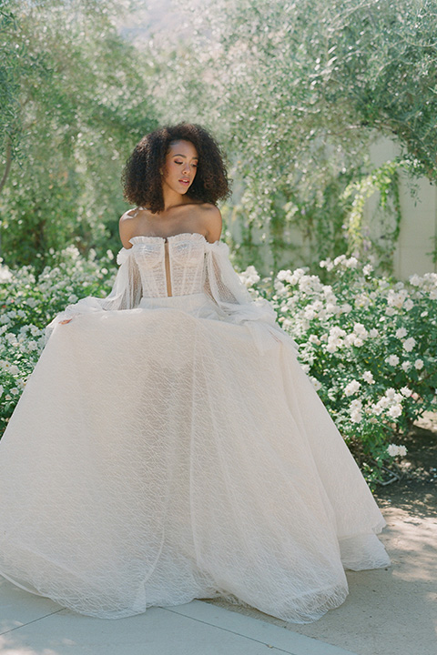  romantic wedding at colony 29 with the bride in a tulle ballgown with sleeves and the groom in a diamond black tuxedo – bride twirling her gown   