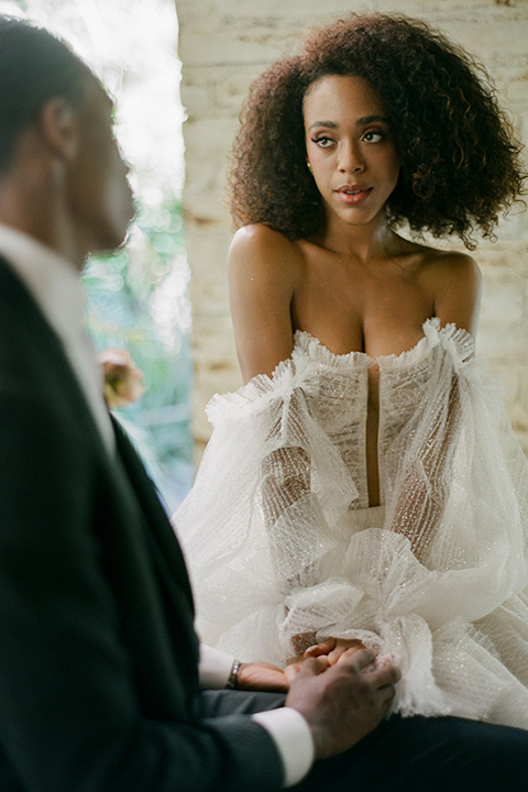  romantic wedding at colony 29 with the bride in a tulle ballgown with sleeves and the groom in a diamond black tuxedo – couple in the garden  