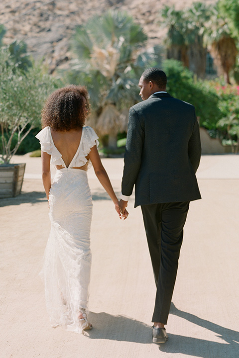  romantic wedding at colony 29 with the bride in a tulle ballgown with sleeves and the groom in a diamond black tuxedo – couple in the garden   