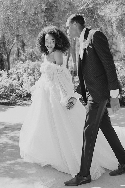  romantic wedding at colony 29 with the bride in a tulle ballgown with sleeves and the groom in a diamond black tuxedo – couple in the garden  