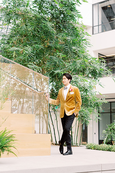  tropical and gold wedding with red accents – groom in a gold velvet tuxedo 