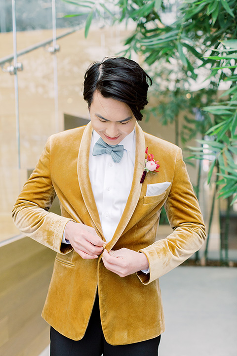 tropical and gold wedding with red accents – groom in gold velvet tuxedo 