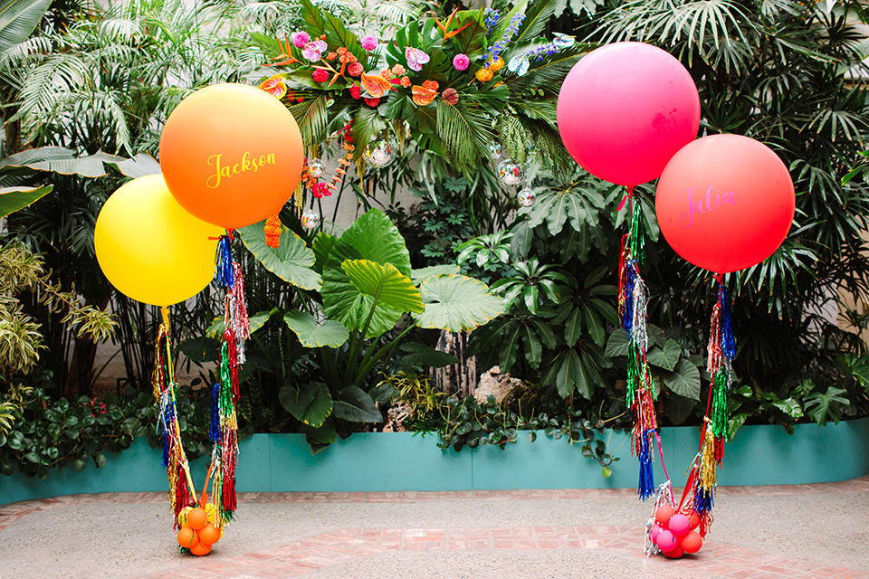  a colorful disco wedding in dtla with the bride in a champagne gown with metallic stars and the groom in a cobalt blue suit –balloon decor