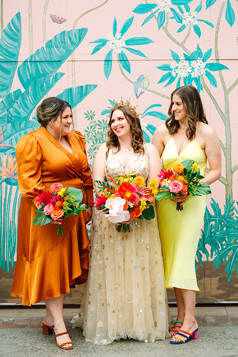  a colorful disco wedding in dtla with the bride in a champagne gown with metallic stars and the groom in a cobalt blue suit – bride and her bridesmaids 