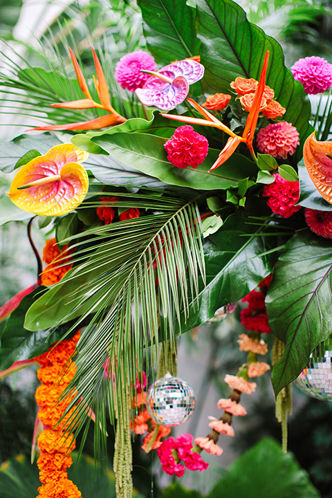  a colorful disco wedding in dtla with the bride in a champagne gown with metallic stars and the groom in a cobalt blue suit – ceremony florals 