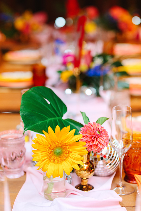  a colorful disco wedding in dtla with the bride in a champagne gown with metallic stars and the groom in a cobalt blue suit – table decor 