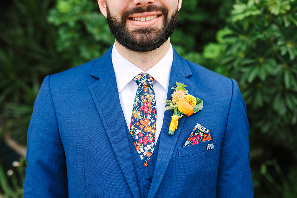  a colorful disco wedding in dtla with the bride in a champagne gown with metallic stars and the groom in a cobalt blue suit – close up on the groom style