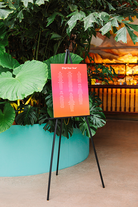  a colorful disco wedding in dtla with the bride in a champagne gown with metallic stars and the groom in a cobalt blue suit – welcome sign 