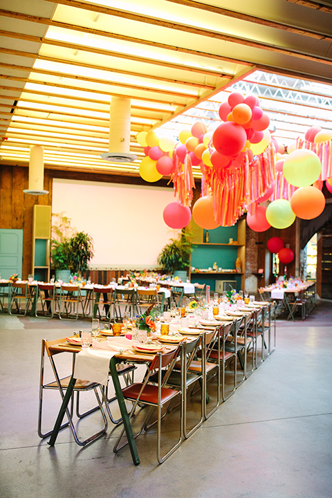  a colorful disco wedding in dtla with the bride in a champagne gown with metallic stars and the groom in a cobalt blue suit – reception decor 