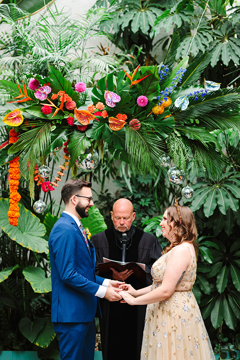  a colorful disco wedding in dtla with the bride in a champagne gown with metallic stars and the groom in a cobalt blue suit – vows