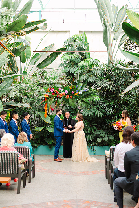  a colorful disco wedding in dtla with the bride in a champagne gown with metallic stars and the groom in a cobalt blue suit – ceremony 