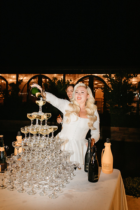  black and white wedding design with luxe details – couple pouring champagne 