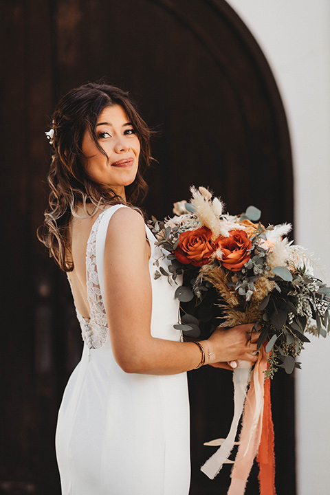  a fall toned wedding at the Fallbrook Estate Wedgewood venue with the groom and groomsmen in grey suits and the bridesmaids in orange – bride in her gown 