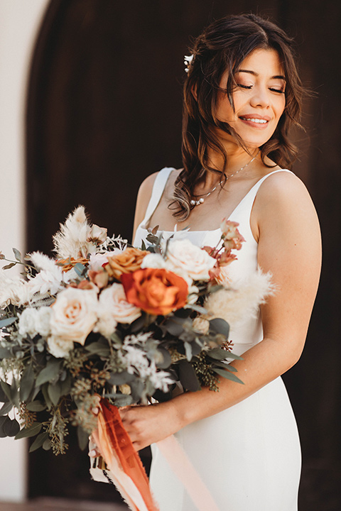  a fall toned wedding at the Fallbrook Estate Wedgewood venue with the groom and groomsmen in grey suits and the bridesmaids in orange – bride in her gown 