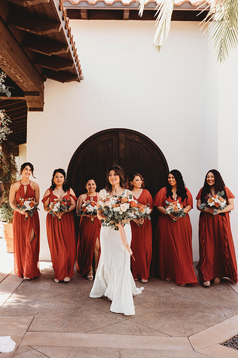  a fall toned wedding at the Fallbrook Estate Wedgewood venue with the groom and groomsmen in grey suits and the bridesmaids in orange – bridesmaids 