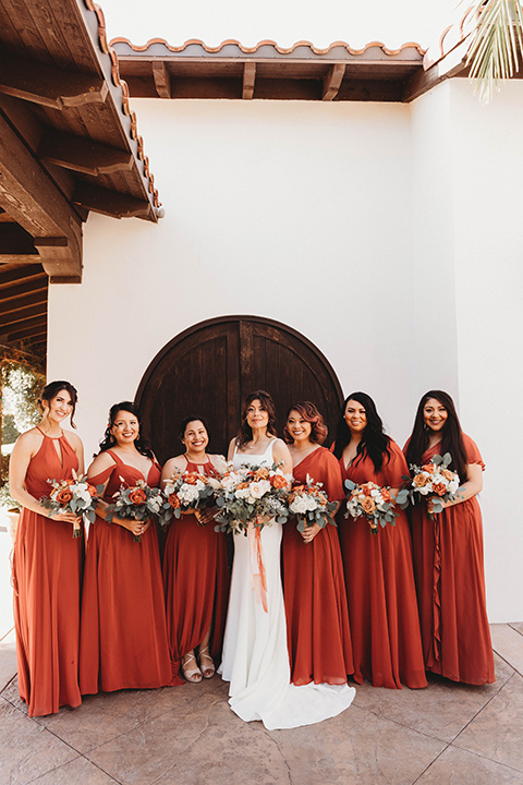  a fall toned wedding at the Fallbrook Estate Wedgewood venue with the groom and groomsmen in grey suits and the bridesmaids in orange – bridesmaids 