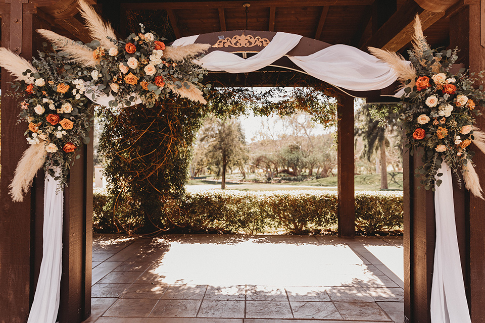  a fall toned wedding at the Fallbrook Estate Wedgewood venue with the groom and groomsmen in grey suits and the bridesmaids in orange – ceremony space 