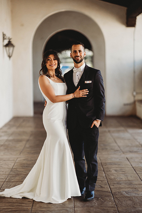  a fall toned wedding at the Fallbrook Estate Wedgewood venue with the groom and groomsmen in grey suits and the bridesmaids in orange – couple walking in the venue