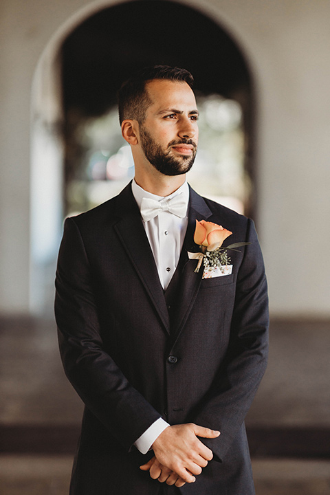  a fall toned wedding at the Fallbrook Estate Wedgewood venue with the groom and groomsmen in grey suits and the bridesmaids in orange – groom in suit