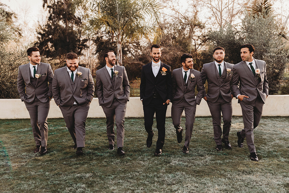  a fall toned wedding at the Fallbrook Estate Wedgewood venue with the groom and groomsmen in grey suits and the bridesmaids in orange – groomsmen walking 