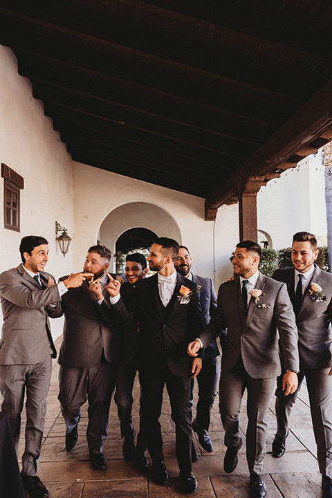  a fall toned wedding at the Fallbrook Estate Wedgewood venue with the groom and groomsmen in grey suits and the bridesmaids in orange – groomsmen
