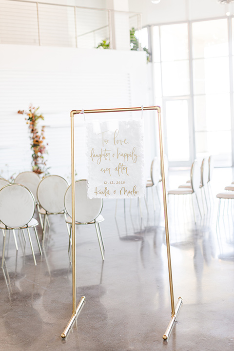 Modern romantic city wedding with an all-white color scheme and bright florals – one bride wore a strapless a-line gown and the other bride wore a white suit – welcome sign 