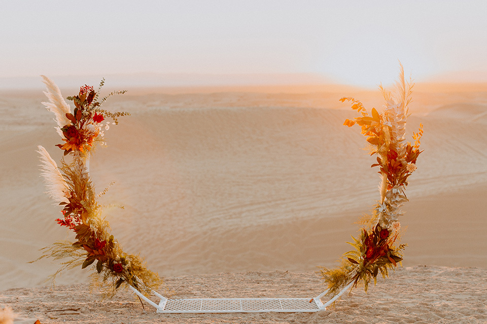  glamis sand dunes wedding with the groom in a tan and a gold velvet tuxedo at sunset – couple at ceremony