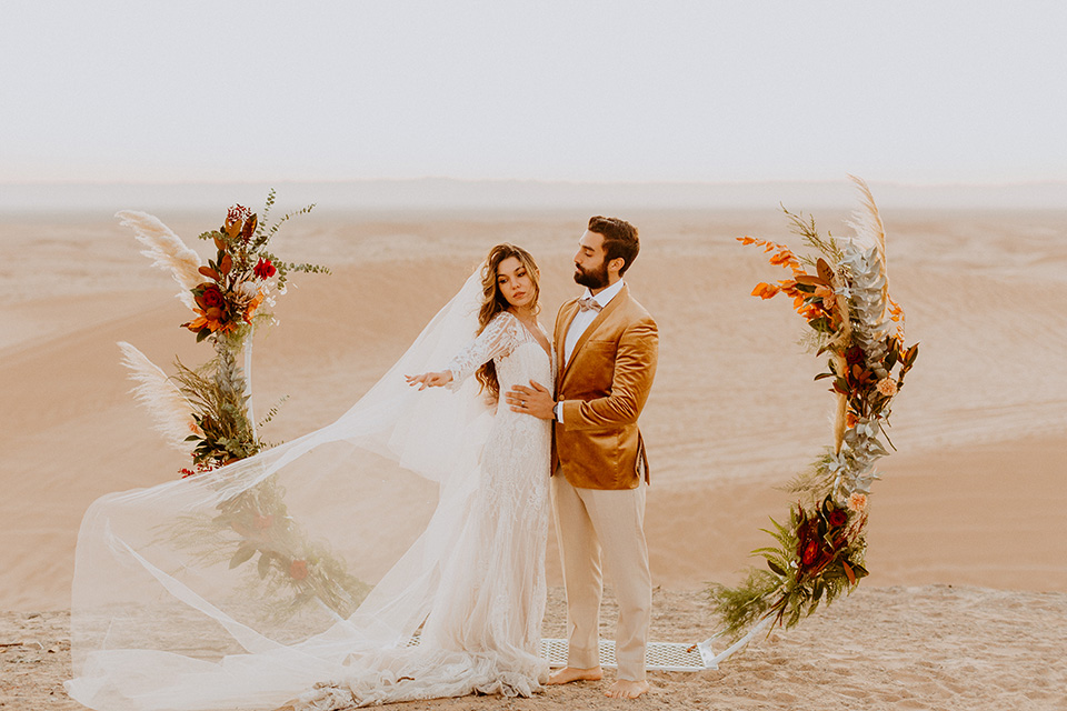  glamis sand dunes wedding with the groom in a tan and a gold velvet tuxedo at sunset – couple at ceremony