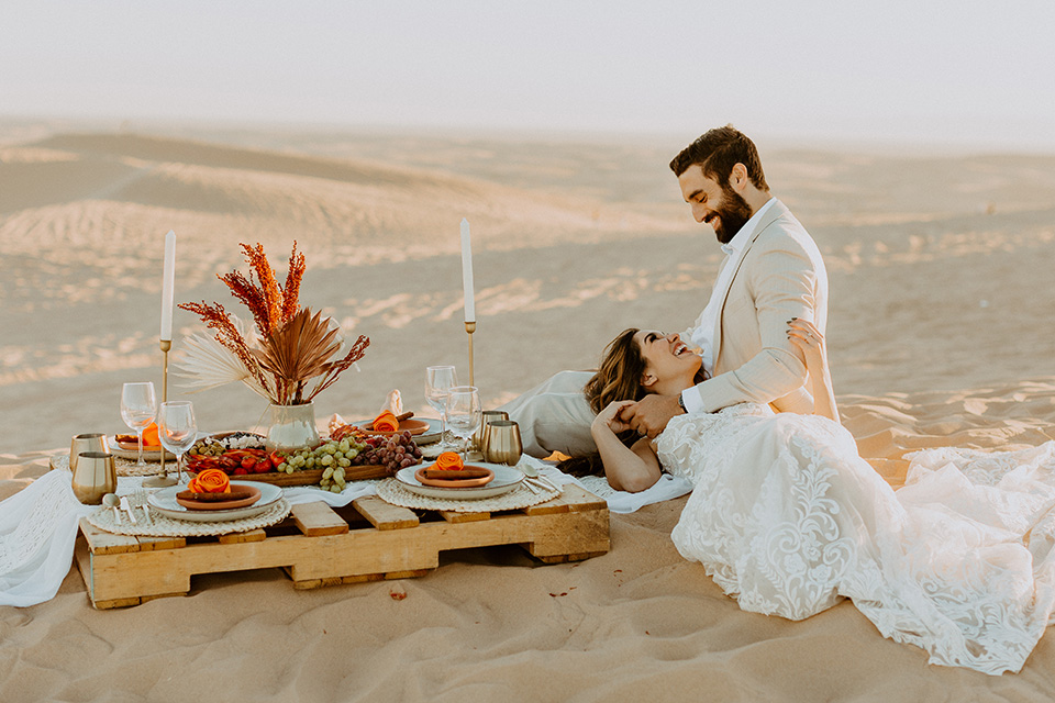  glamis sand dunes wedding with the groom in a tan and a gold velvet tuxedo at sunset – couple at ceremony