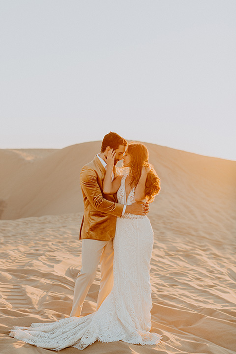  glamis sand dunes wedding with the groom in a tan and a gold velvet tuxedo at sunset – couple at ceremony 