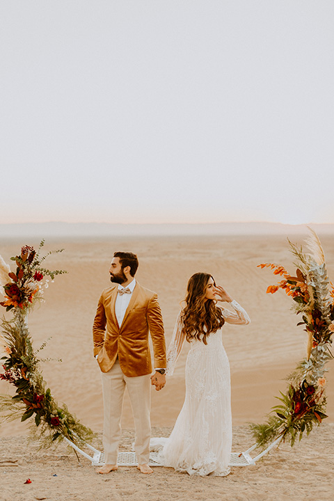  glamis sand dunes wedding with the groom in a tan and a gold velvet tuxedo at sunset – couple at ceremony 