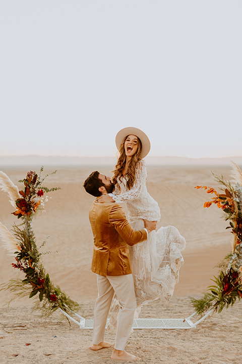  glamis sand dunes wedding with the groom in a tan and a gold velvet tuxedo at sunset – couple at ceremony 