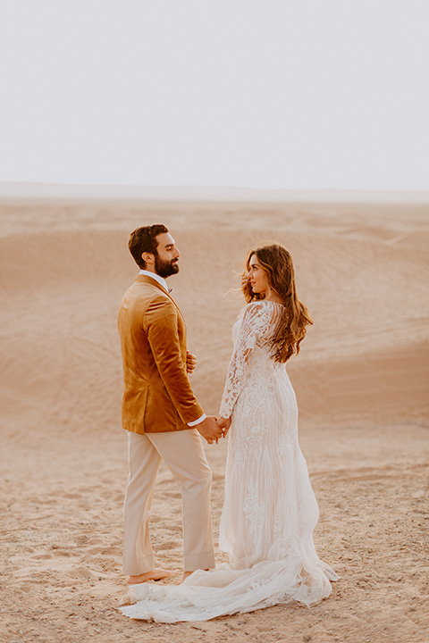  glamis sand dunes wedding with the groom in a tan and a gold velvet tuxedo at sunset – couple at ceremony 