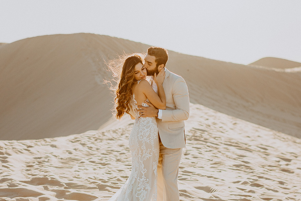  glamis sand dunes wedding with the groom in a tan and a gold velvet tuxedo at sunset – couple at ceremony