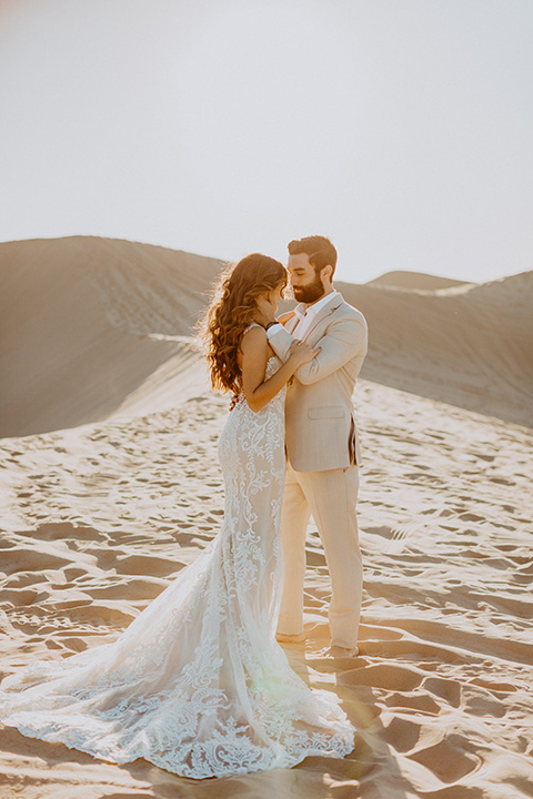  glamis sand dunes wedding with the groom in a tan and a gold velvet tuxedo at sunset – couple at ceremony 