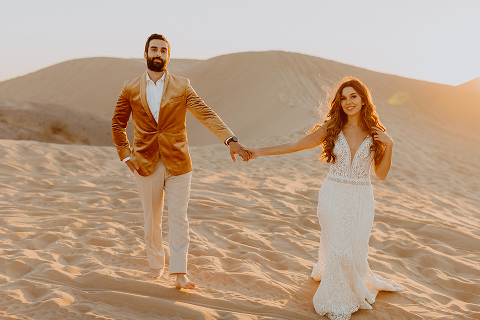  glamis sand dunes wedding with the groom in a tan and a gold velvet tuxedo at sunset – couple at ceremony