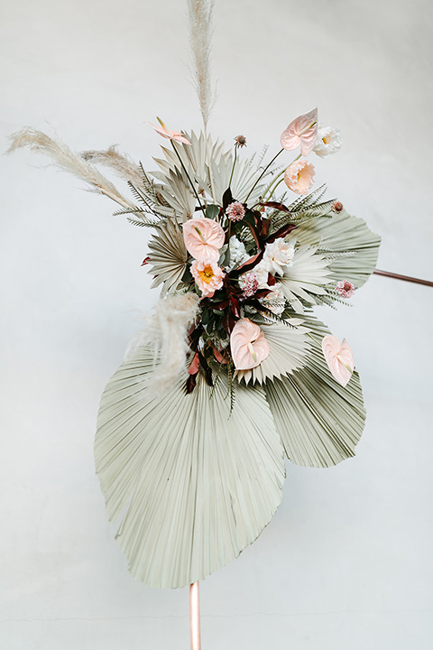  tropical metallic wedding with the bride in an ivory lace gown and the groom in a green suit 