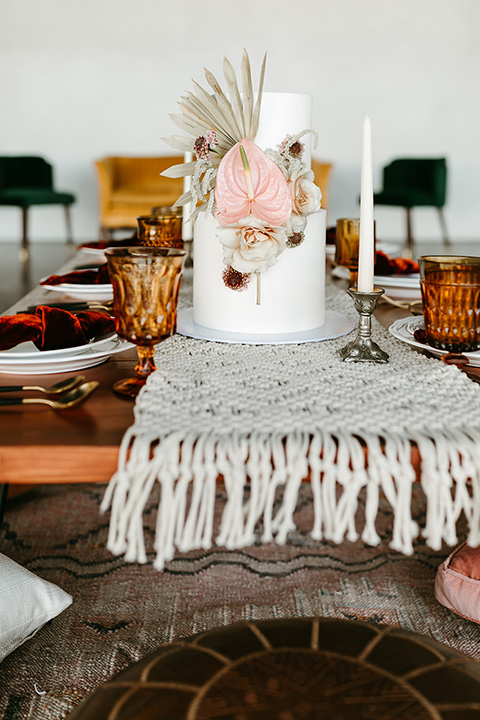  tropical metallic wedding with the bride in an ivory lace gown and the groom in a green suit 