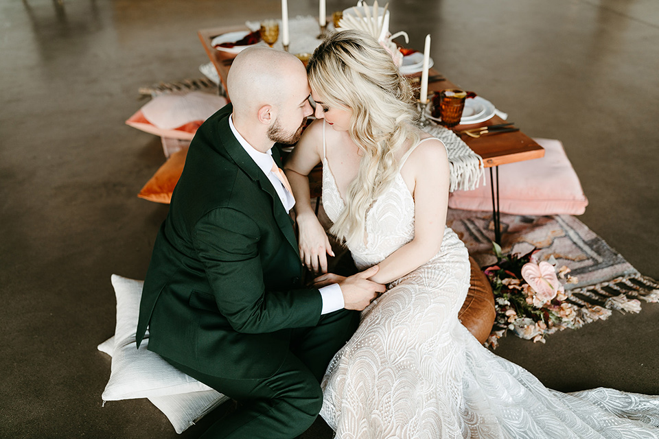  tropical metallic wedding with the bride in an ivory lace gown and the groom in a green suit 