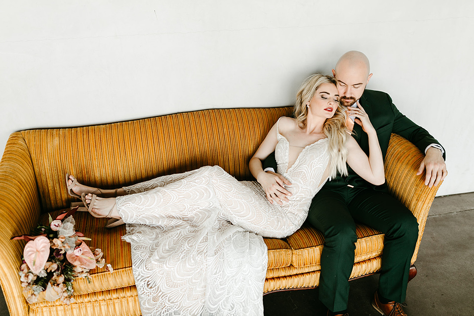  tropical metallic wedding with the bride in an ivory lace gown and the groom in a green suit 